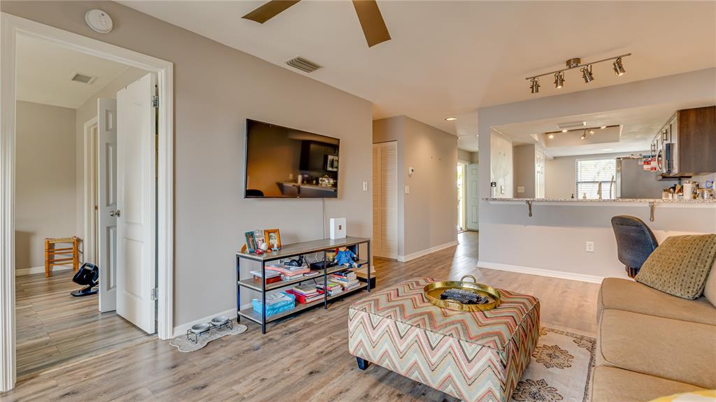 6145 113th Street, Unit 415 Seminole, FL 33772 - Photo 7 of 35 a living room with furniture and a flat screen tv