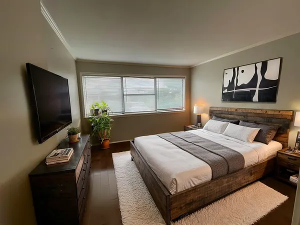 a bedroom with a bed and a flat screen tv
