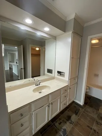 a spacious bathroom with a double vanity sink and mirror