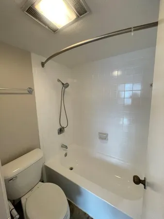 a bathroom with a toilet and a shower