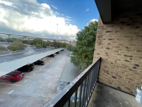 a view of a balcony with wooden floor and fence