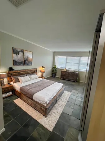 a bedroom with a bed and window