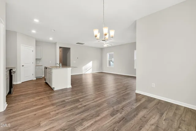 a view of a kitchen with sink and wooden floor