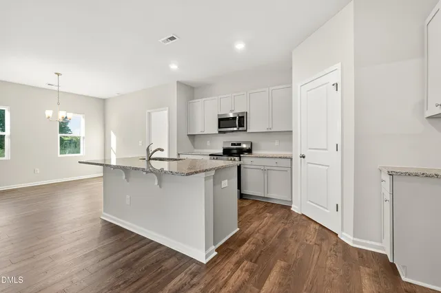 a kitchen with stainless steel appliances a refrigerator sink and microwave