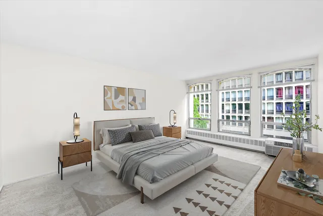 a bedroom with a bed and a couch