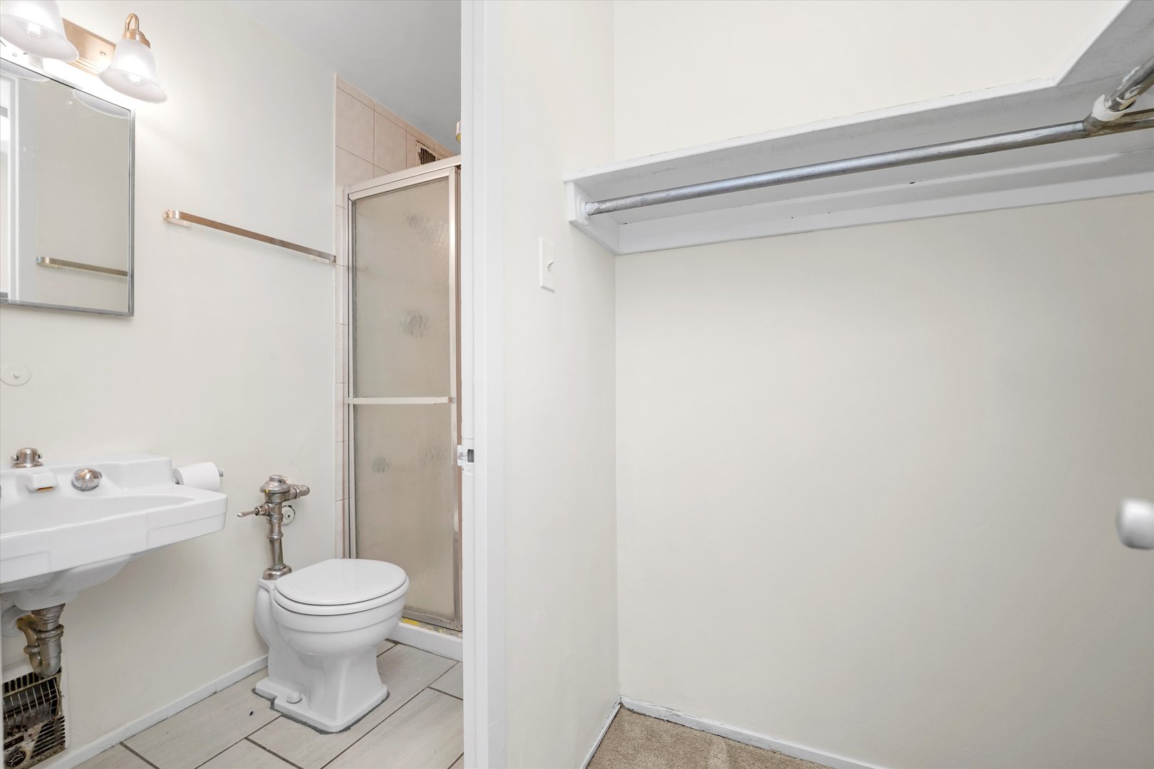1450 East 55th Place, Unit 317S Chicago, IL 60637 - Photo 13 of 25 a white toilet sitting next to a bathroom sink