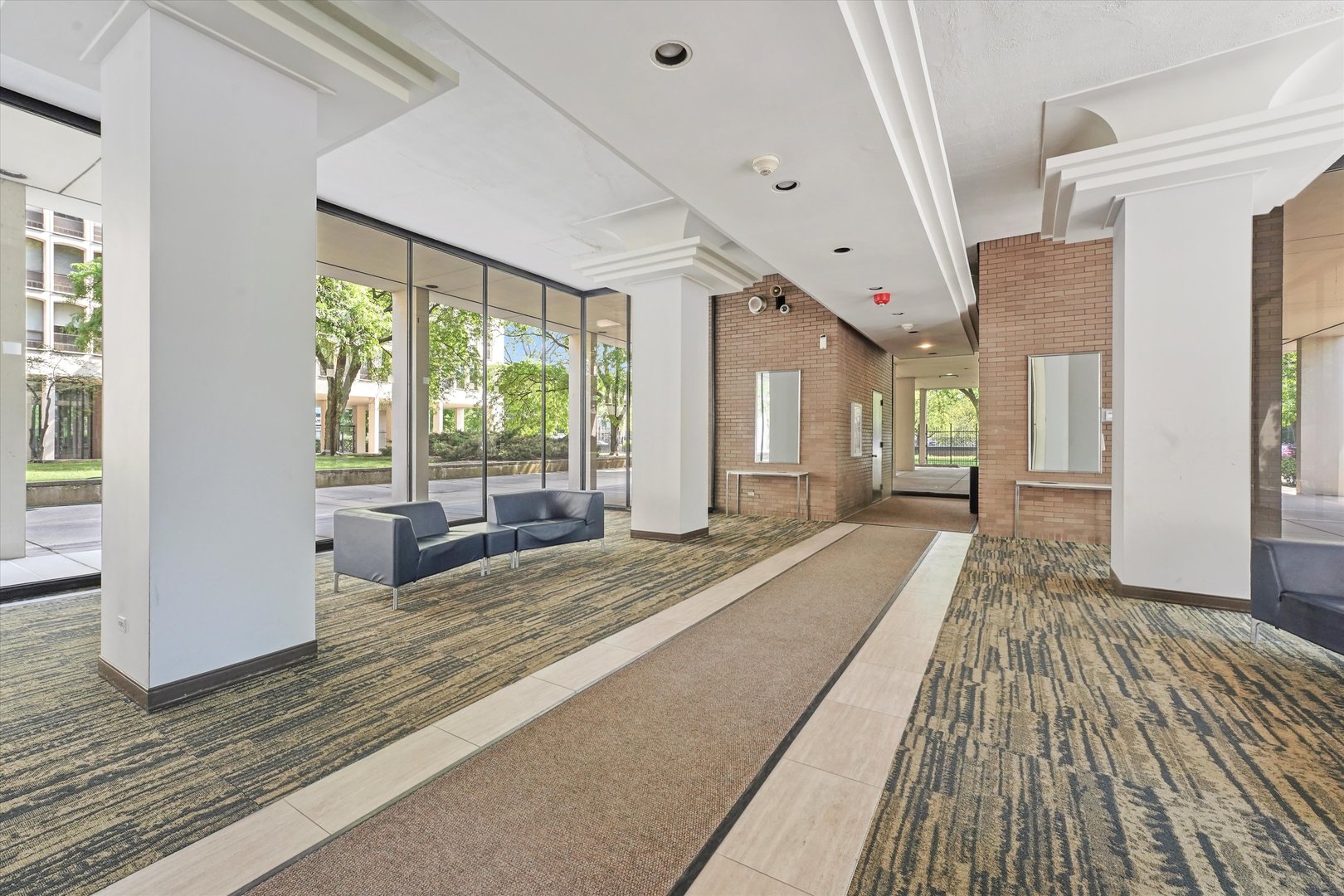 1450 East 55th Place, Unit 317S Chicago, IL 60637 - Photo 3 of 25 a spacious bedroom with a large window a bed and windows