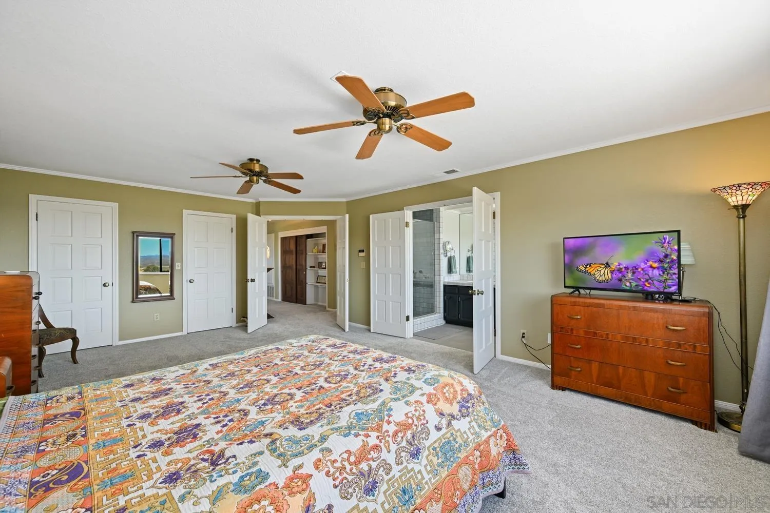 1282 Olive Avenue Fallbrook, CA 92028 - Photo 22 of 55 a bedroom with a bed and a chandelier