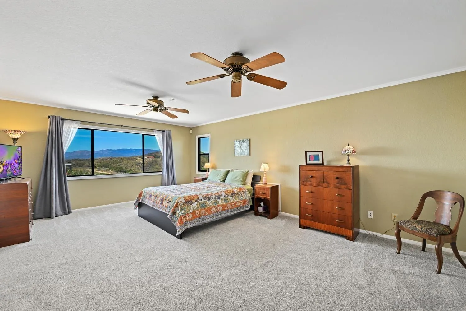 1282 Olive Avenue Fallbrook, CA 92028 - Photo 23 of 55 a bedroom with a bed and a chandelier