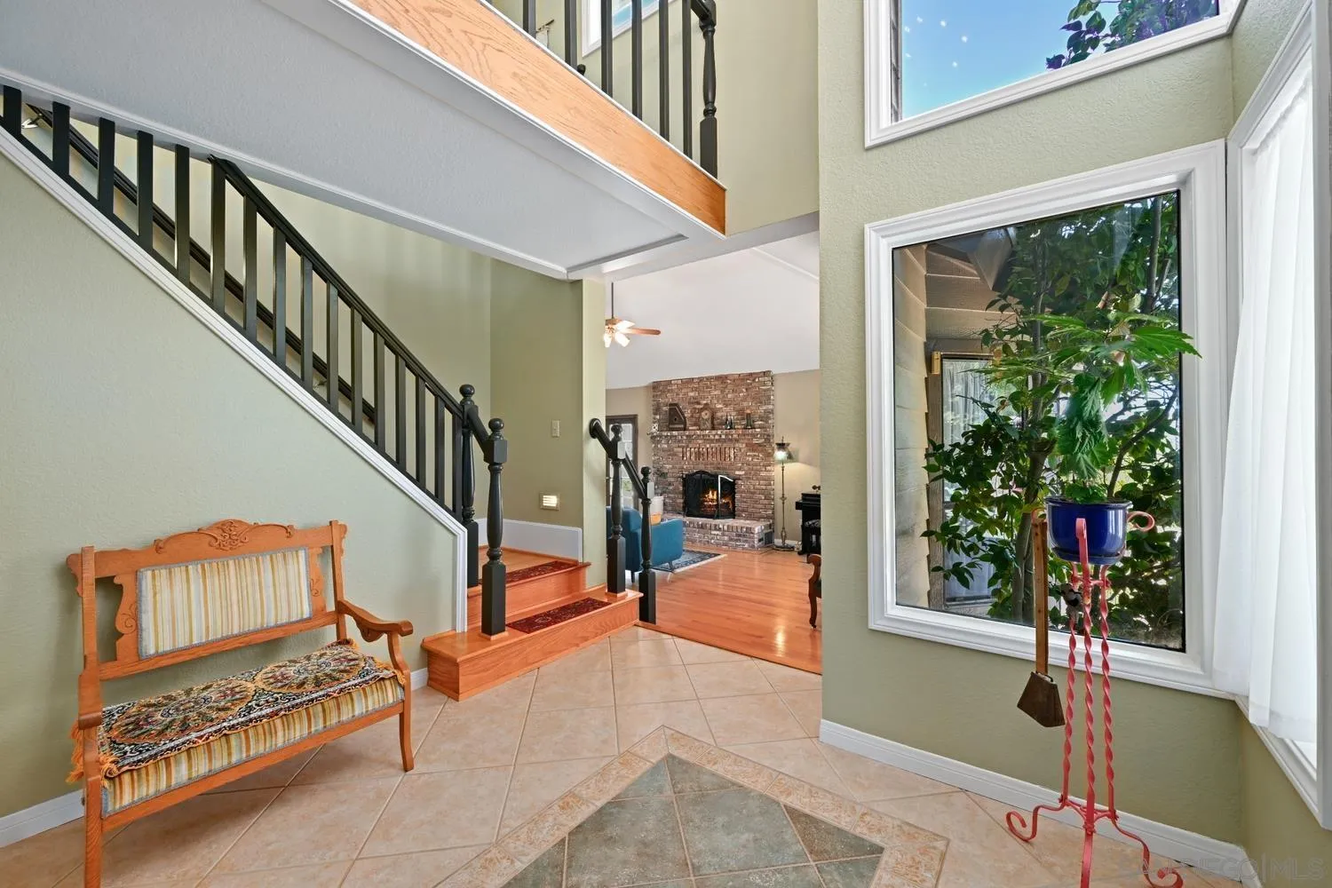 1282 Olive Avenue Fallbrook, CA 92028 - Photo 5 of 55 a living room with furniture and a potted plant next to a window