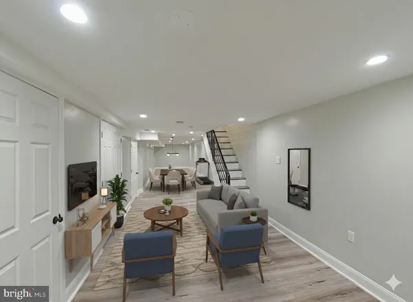 a living room with furniture a flat screen tv and kitchen view