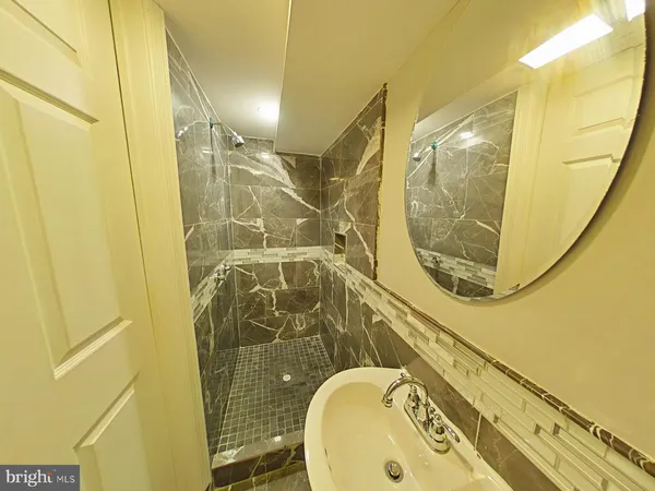a bathroom with a sink and shower