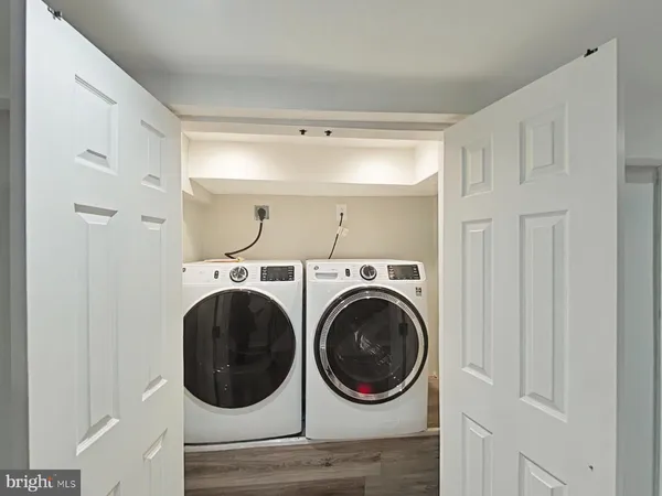 a view of a hallway with washer and dryer