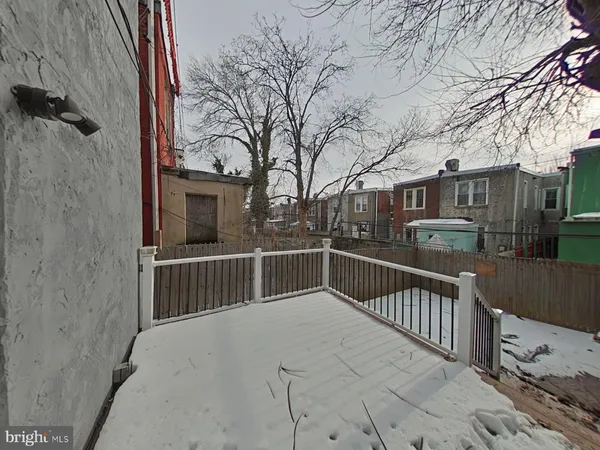 a view of a house with wooden fence