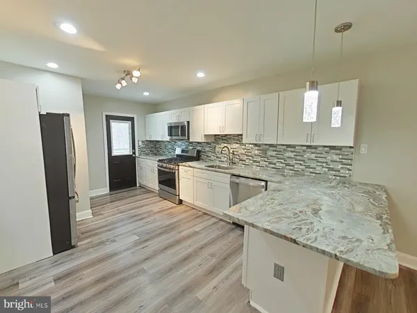 a kitchen with a sink stove and refrigerator