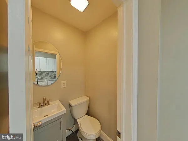 a white toilet sitting next to a bathroom sink
