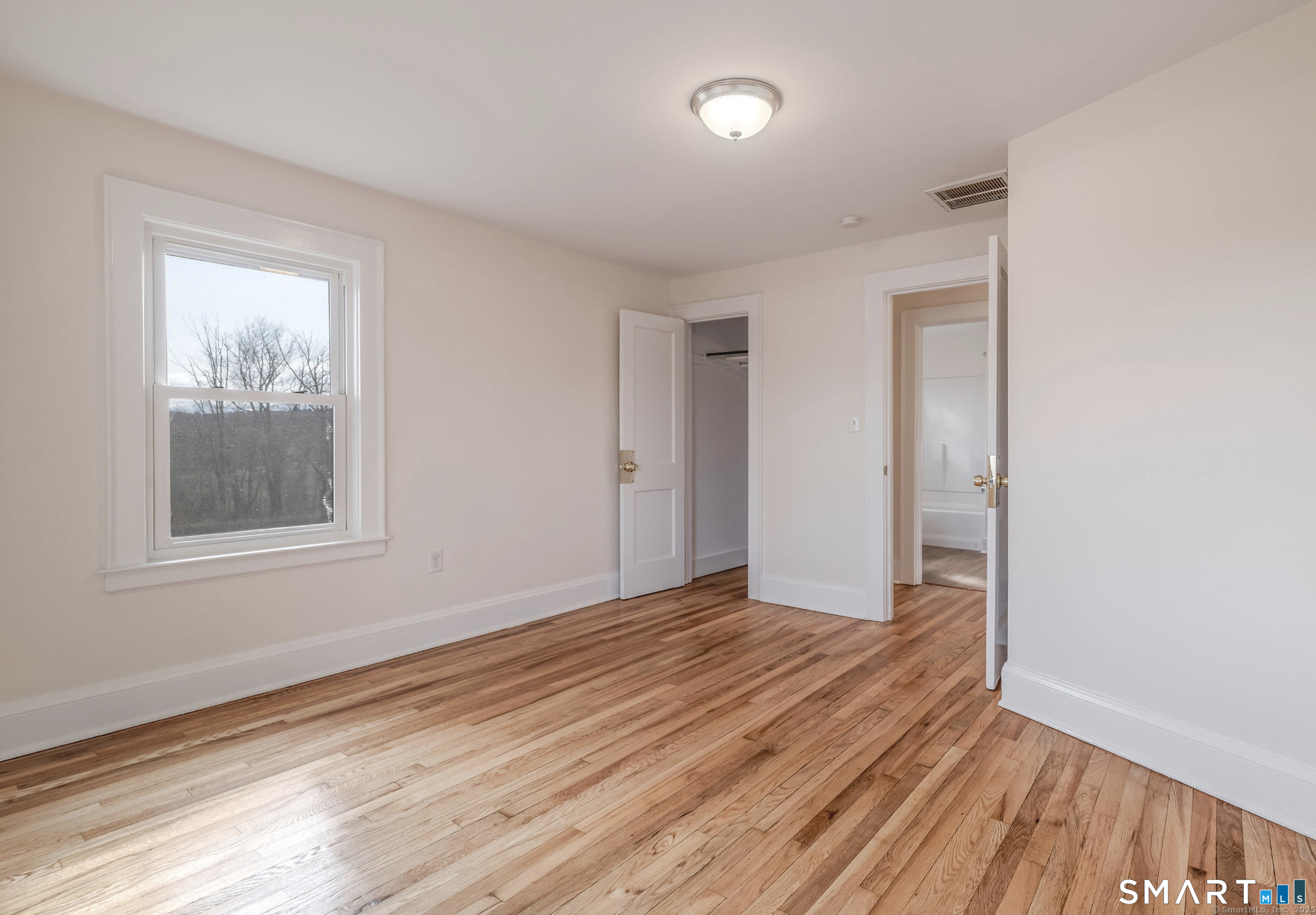 11 Piney Ridge Road Cromwell, CT 06416 - Photo 14 of 19 an empty room with wooden floor and windows