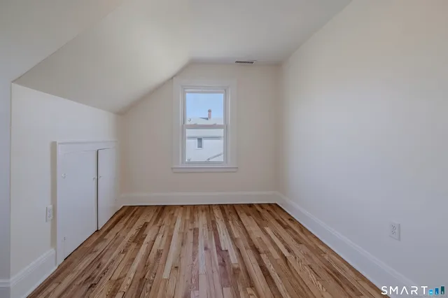a view of room with window and hardwood floor