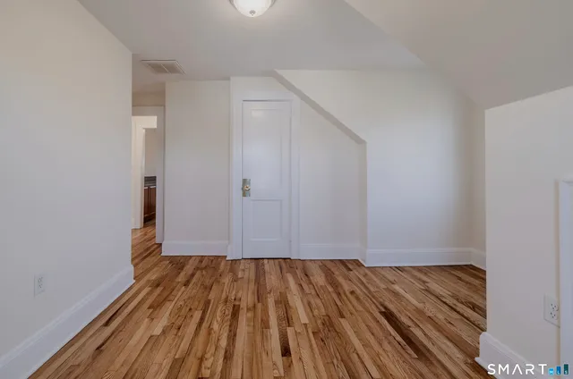 a view of room with wooden floor