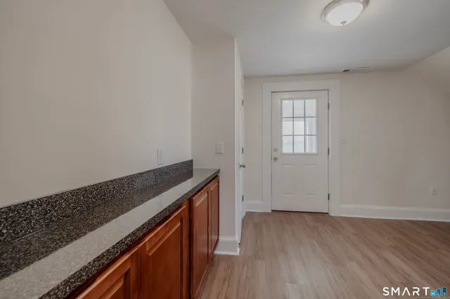 an empty room with wooden floor