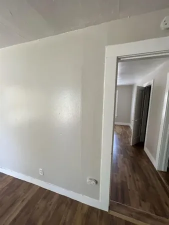 a view of a room with wooden floor