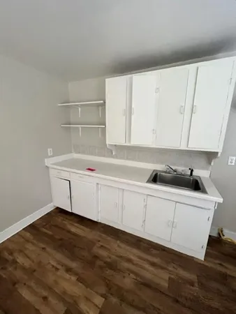 a room with a sink and cabinets