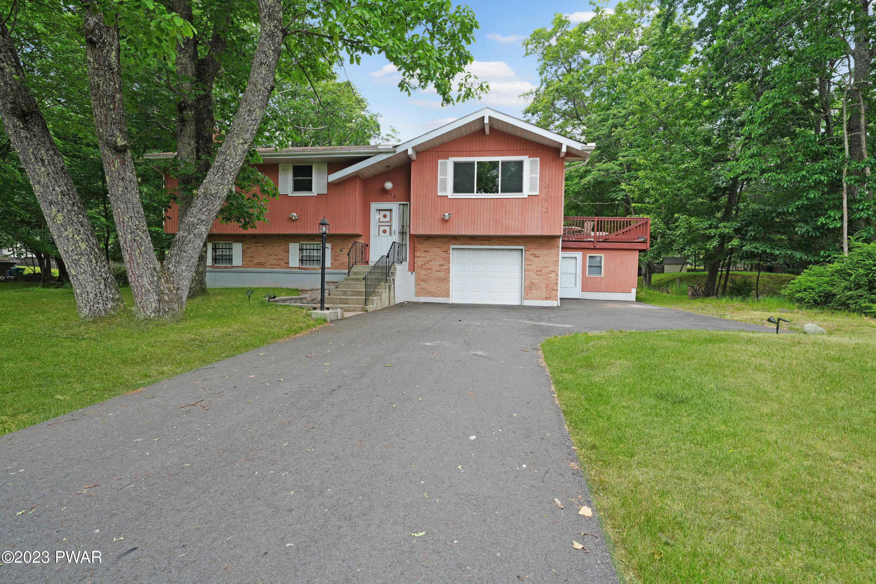 173 Skyview Road Dingmans Ferry, PA 18328 - Photo 2 of 33 a front view of a house with a garden