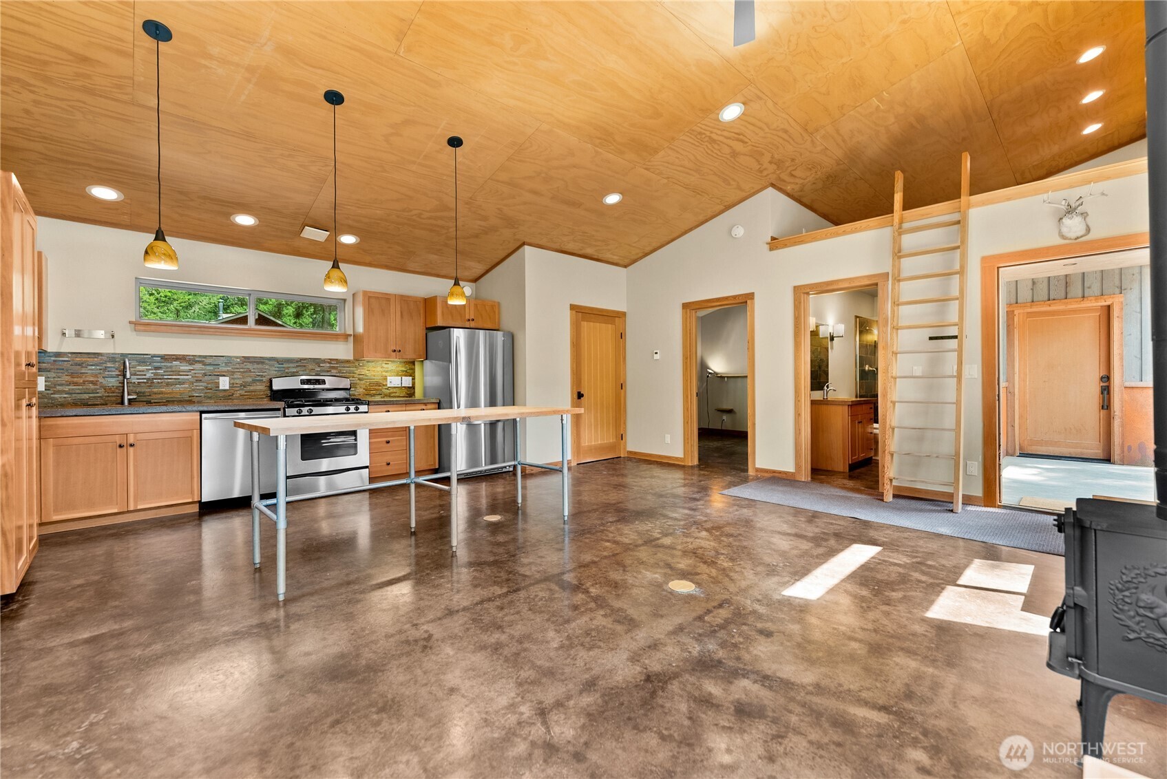 16 Littell Road Mazama, WA 98833 - Photo 28 of 40 a view of a kitchen with stainless steel appliances granite countertop a stove a sink a dining table and chairs