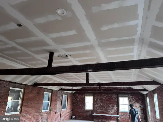 a view of a room with gym equipment and a window