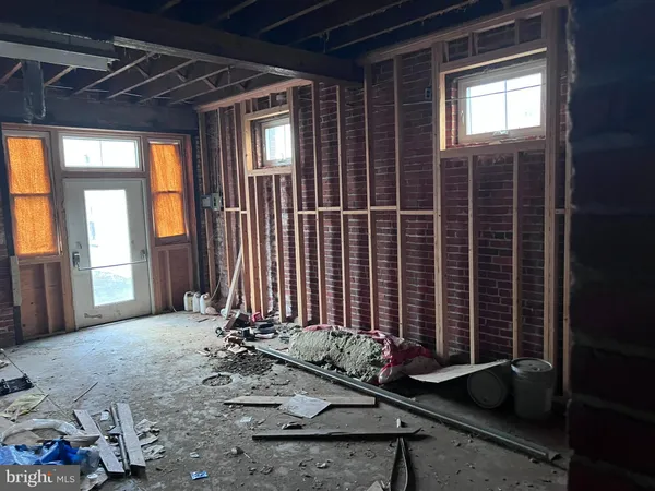 a room with water heater and wooden racks