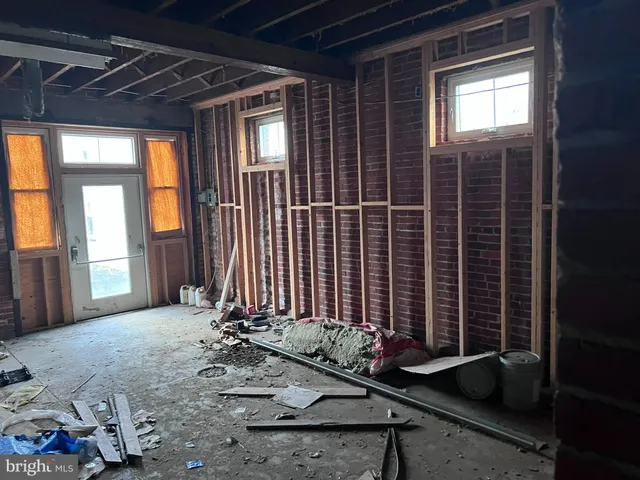 a room with water heater and wooden racks