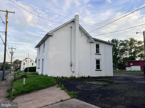 a view of a white house with a yard