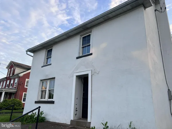 a front view of a house with large windows