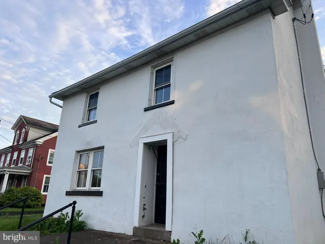 a front view of a house with large windows
