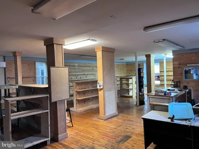 a living room with furniture a flat screen tv and kitchen view