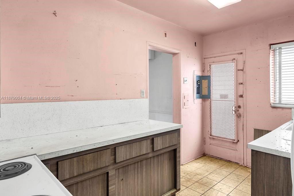 515 West 30th Street Miami Beach, FL 33140 - Photo 12 of 30 a kitchen with a sink a refrigerator and cabinets