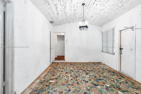 a view of a hallway with a chandelier fan and wooden floor