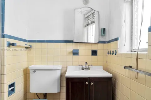 a bathroom with a sink a toilet and mirror