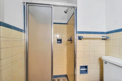 a bathroom with a shower and a glass door