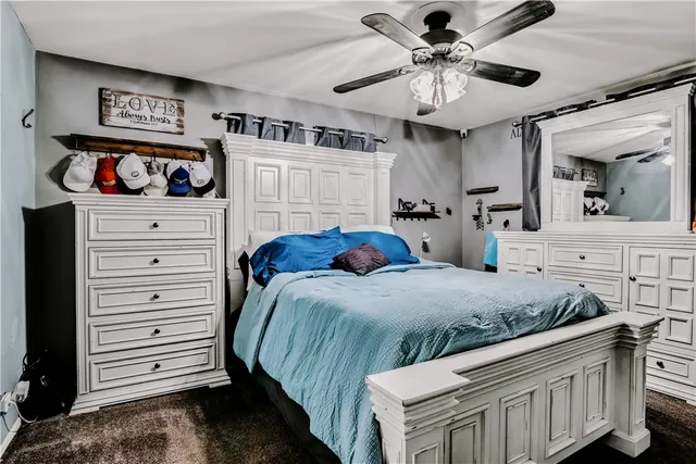 a bedroom with a bed and a chandelier