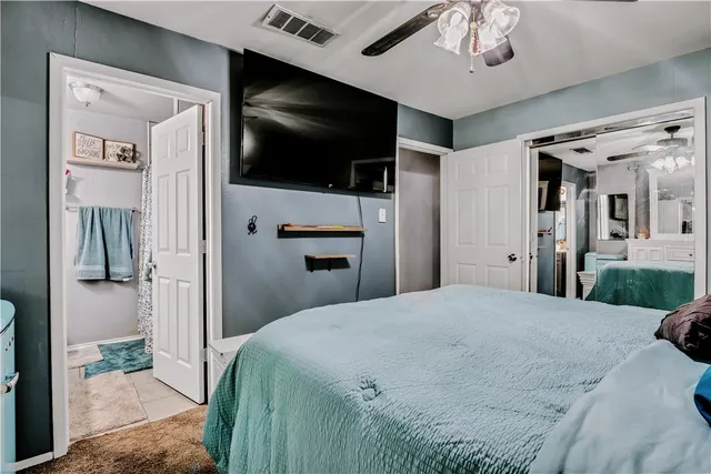 a bedroom with a bed and a flat screen tv