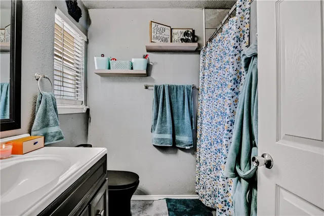a bathroom with a sink toilet and a shower