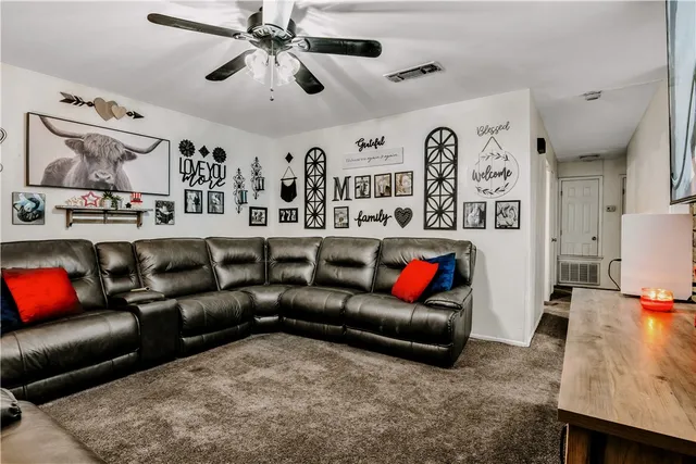 a living room with furniture and kitchen view