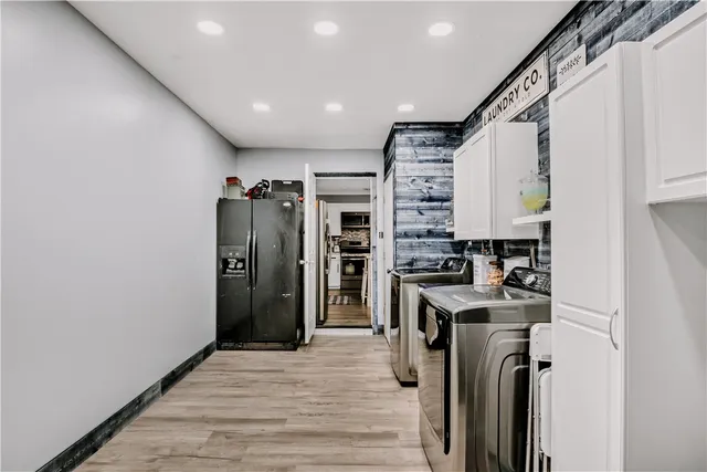 a kitchen with stainless steel appliances granite countertop a refrigerator a stove and a sink