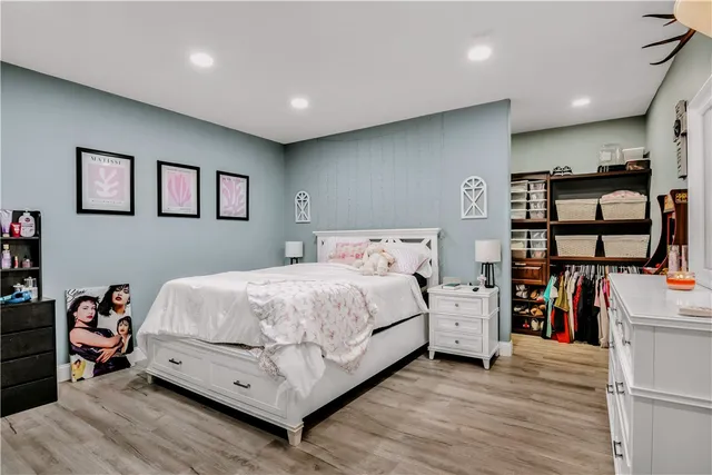 a bed room with a bed and a book shelf