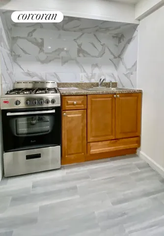 a stove top oven sitting inside of a kitchen