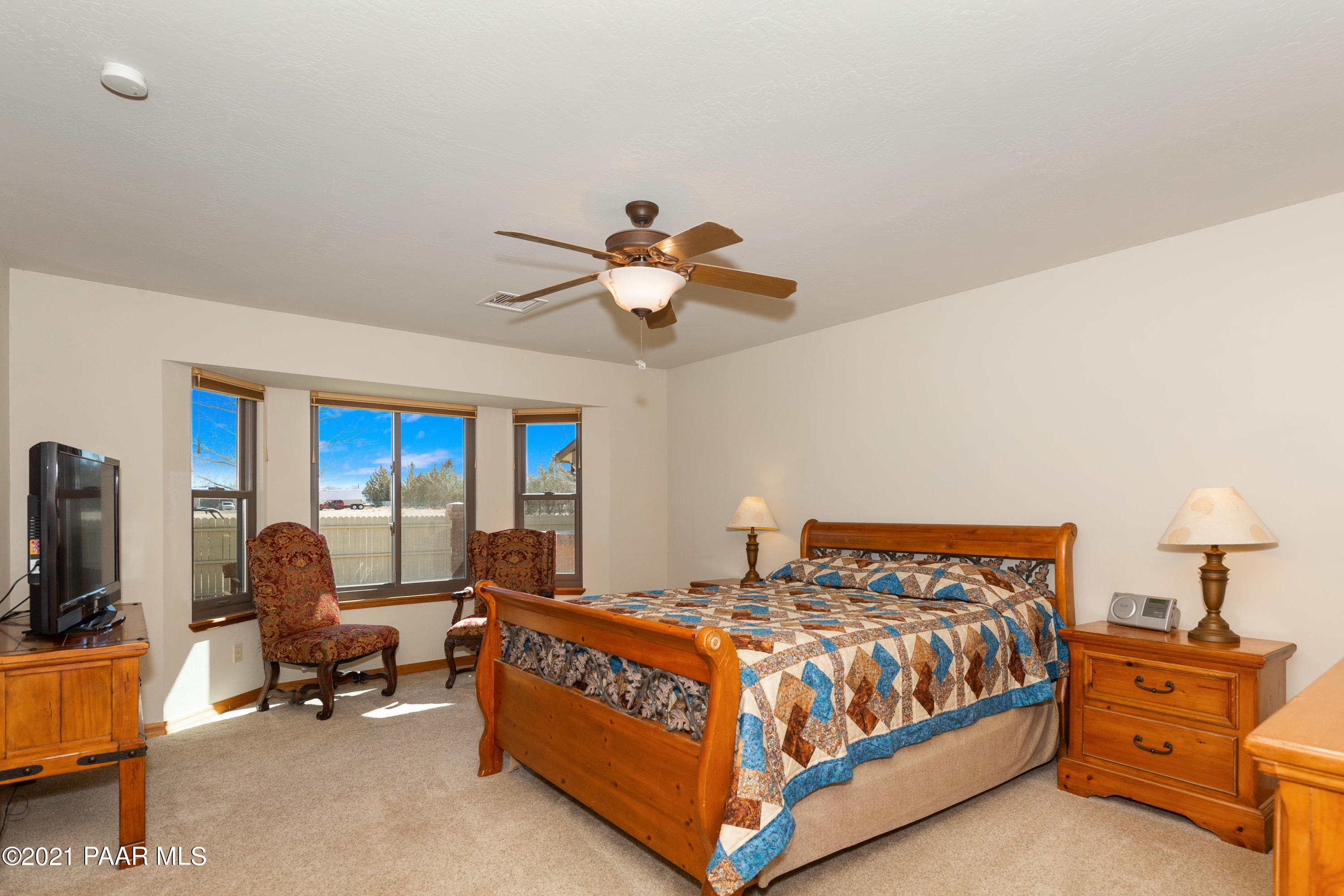 3727 North Reed Road Chino Valley, AZ 86323 - Photo 11 of 45 a bedroom with a bed and a chandelier