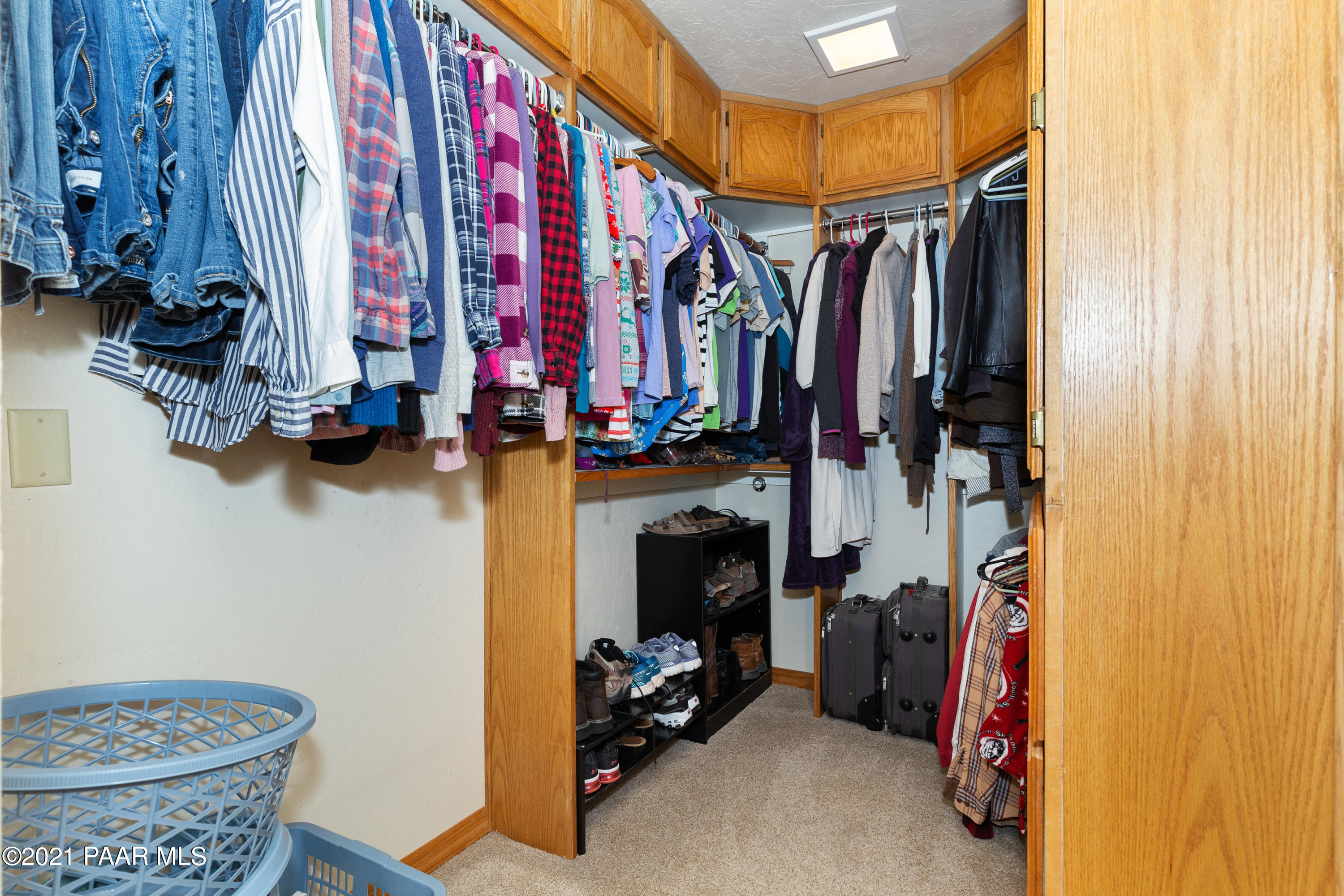 3727 North Reed Road Chino Valley, AZ 86323 - Photo 14 of 45 a view of walk in closet with clothes and shoes