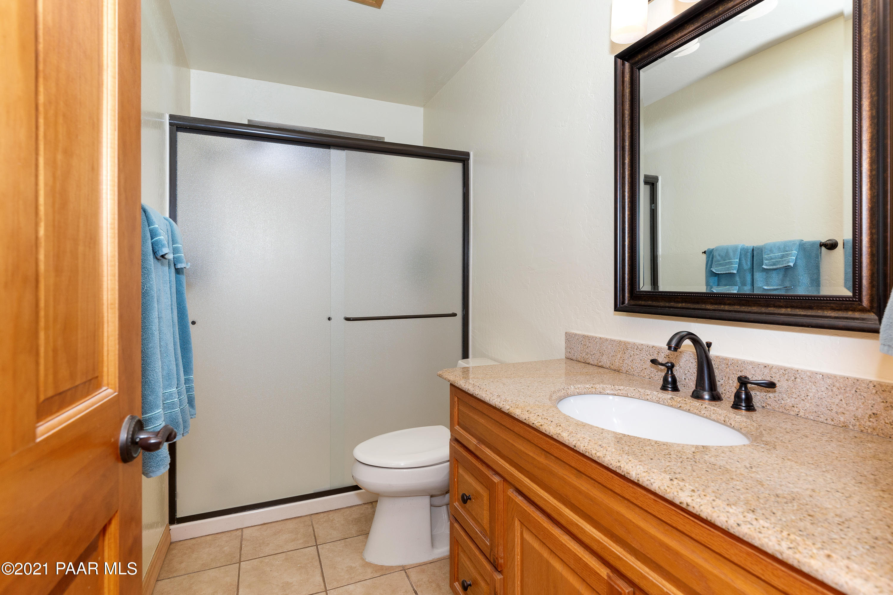 3727 North Reed Road Chino Valley, AZ 86323 - Photo 16 of 45 a bathroom with a granite countertop sink mirror vanity and toilet