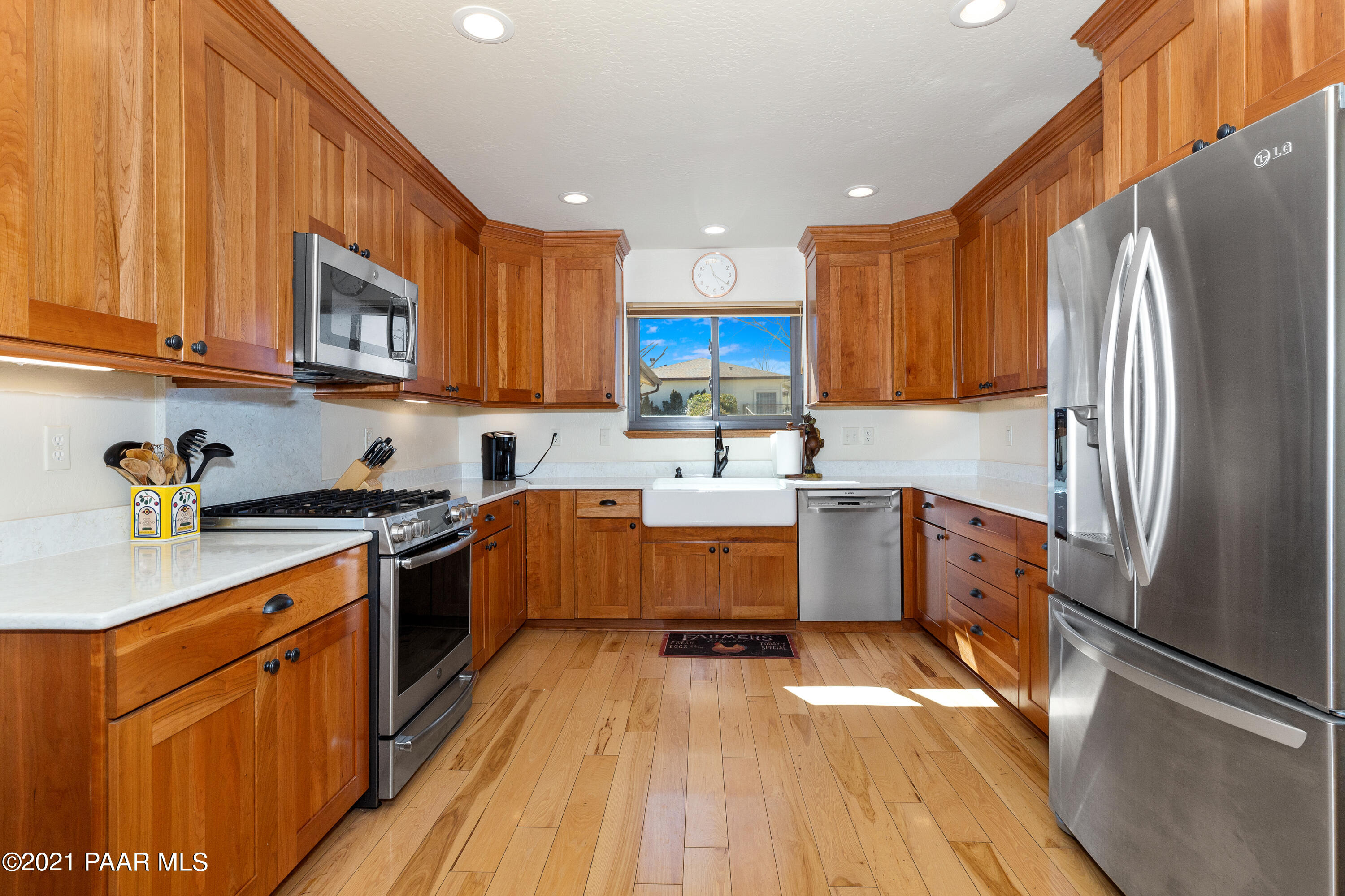 3727 North Reed Road Chino Valley, AZ 86323 - Photo 8 of 45 a kitchen with stainless steel appliances granite countertop a refrigerator a stove top oven a sink and dishwasher with wooden floor